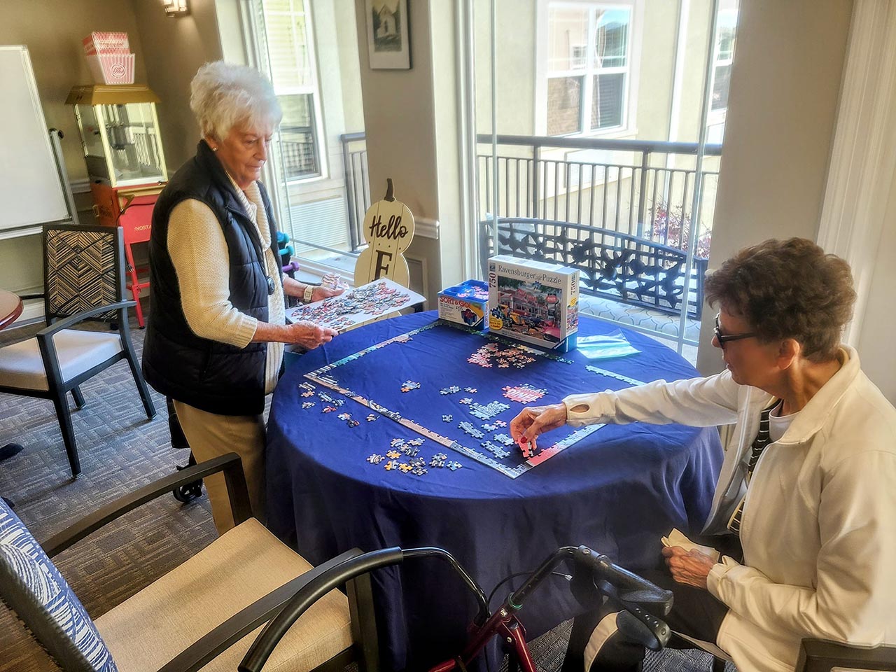 two senior friends putting together a puzzle